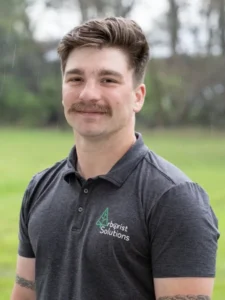 Arborist Solutions team member in company polo shirt